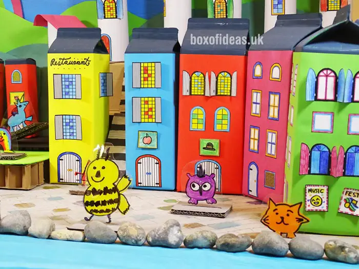 Colorful juice-box buildings for a recycled town project. A fun DIY kids craft toy made out of recycling. #recycledcrafts #kidscrafts