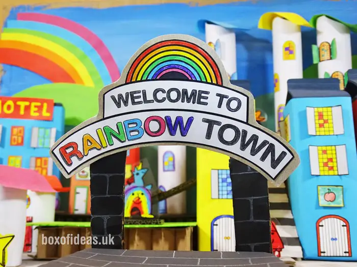 Welcome to Rainbow town sign for a recycled town project. A fun DIY kids craft toy made out of recycling #rainbows #kidscraft #papertown