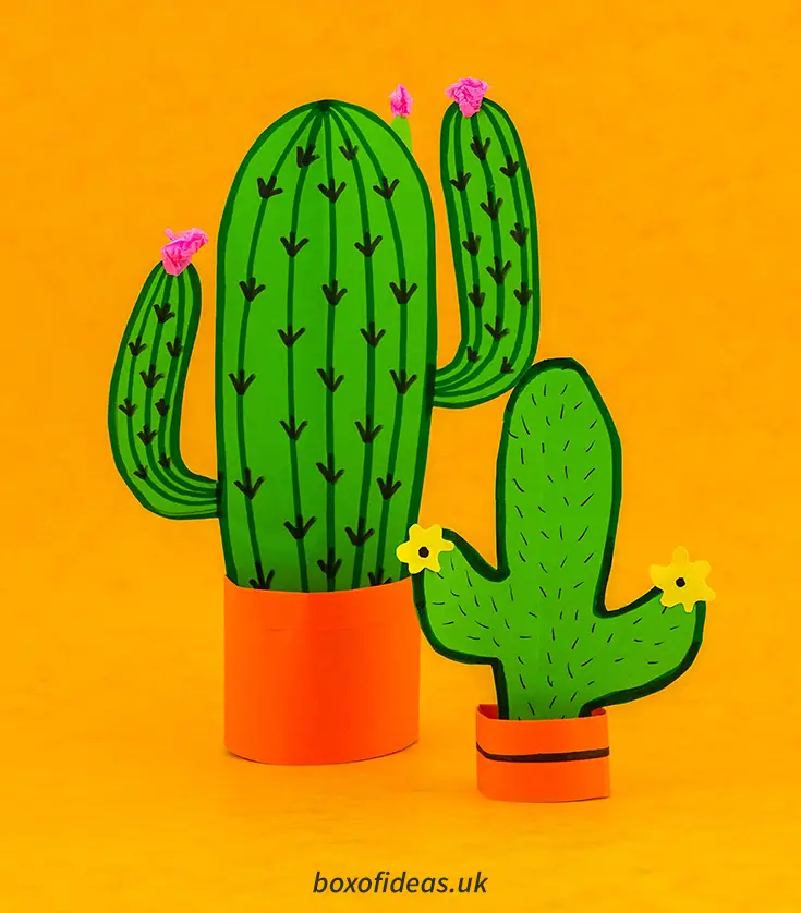 Pair Resting 3-d cactus crafts next to the book 60 easy paper projects #papercraft #kidscraft #craftsforkids #cactus #easycrafts #boxofideasof simple 3-d cactus craft with flowers in an orange pot #papercraft #kidscraft #craftsforkids #cactus #easycrafts #boxofideas