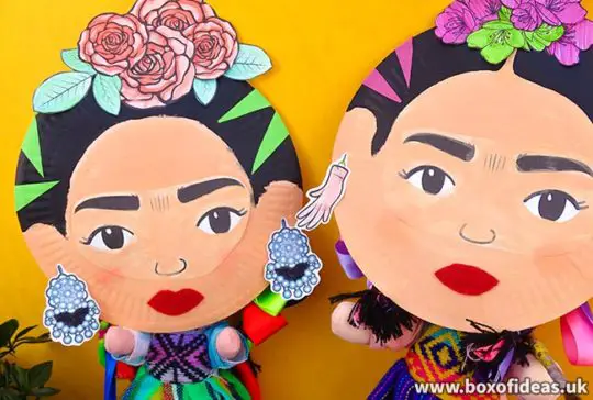 Two Frida Kahlo crafts for kids made with paper plates posing as if they were taking a selfie.
